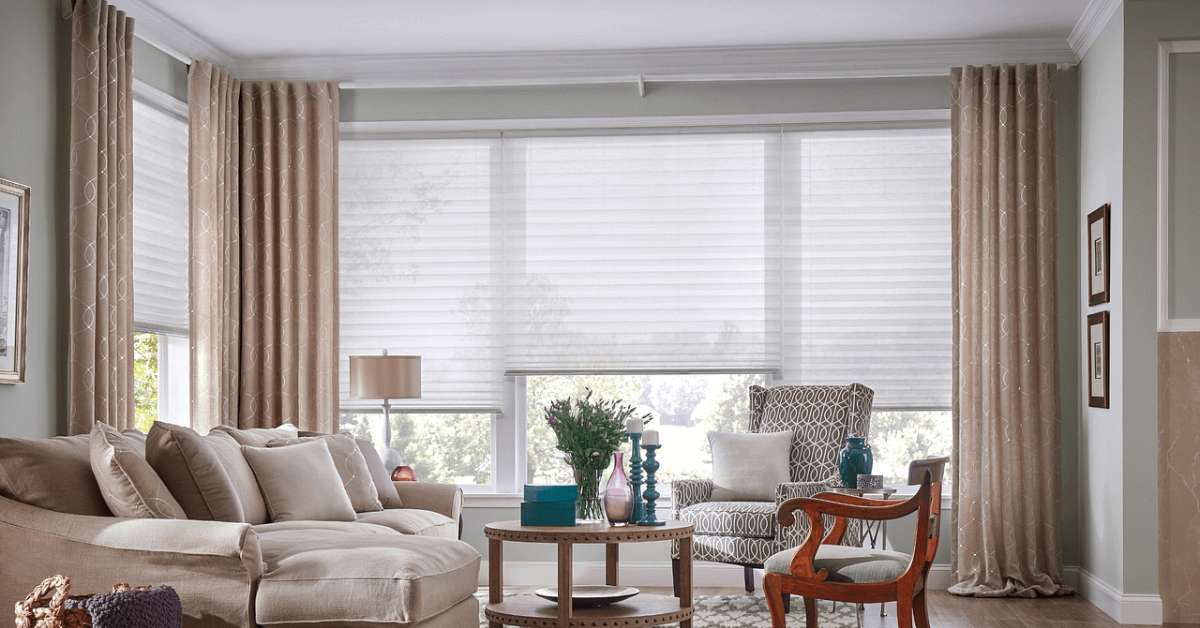 living room adorned with stylish drapes and cellular shades for elegant window treatment