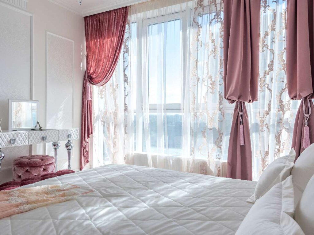 stunning sheer and velvet drapes, embodying the latest trend in window treatments.