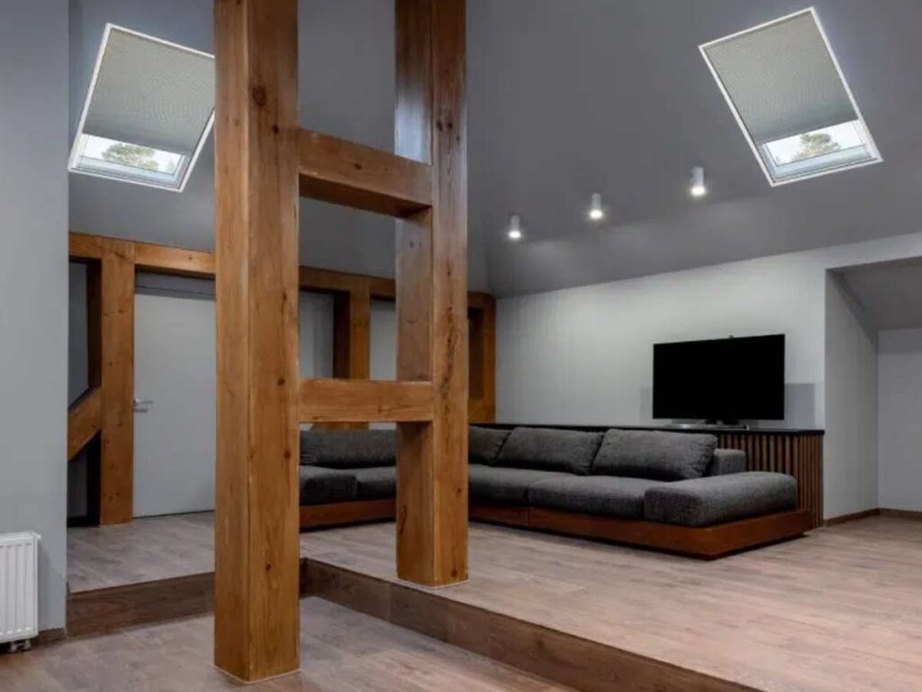 sunlit living room with elegant window coverings framing skylights.